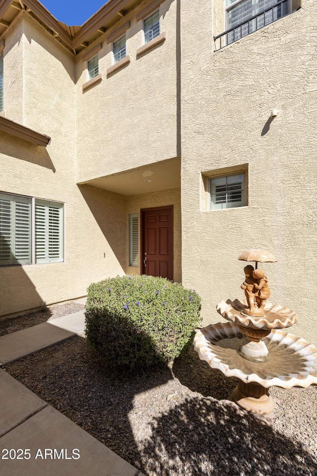 doorway to property with stucco siding