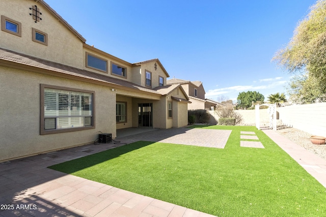 view of yard featuring central AC, a patio area, and a fenced backyard