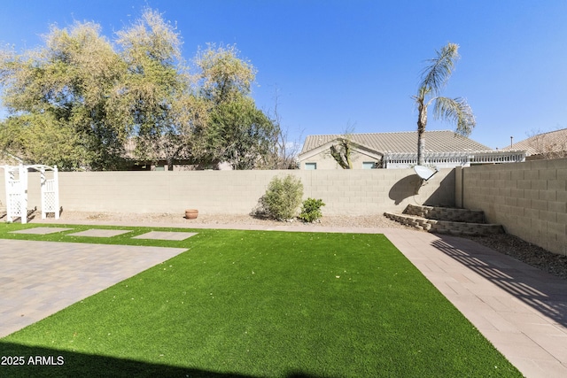 view of yard featuring a fenced backyard and a patio