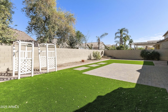 view of yard with a patio area and a fenced backyard