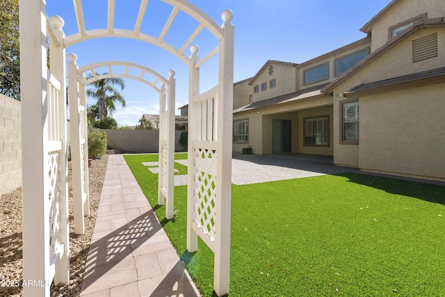 view of yard featuring fence and a patio