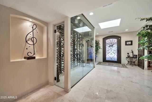 entryway with visible vents, recessed lighting, a skylight, and baseboards