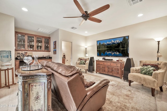 living area with light tile patterned floors, recessed lighting, visible vents, and ceiling fan