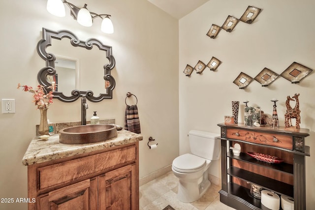 bathroom featuring tile patterned floors, toilet, vanity, and baseboards