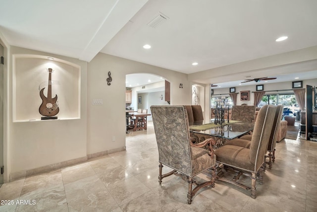 dining space with visible vents, baseboards, ceiling fan, recessed lighting, and arched walkways