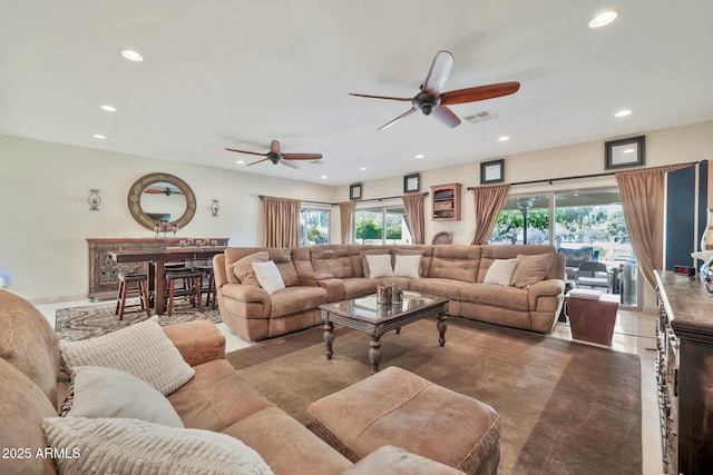 living room with recessed lighting, visible vents, and a ceiling fan