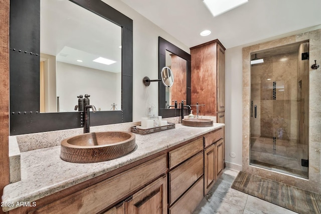 full bathroom featuring double vanity, recessed lighting, a shower stall, and a sink