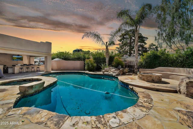 view of swimming pool featuring a patio, a fenced in pool, fence, and an outdoor fire pit