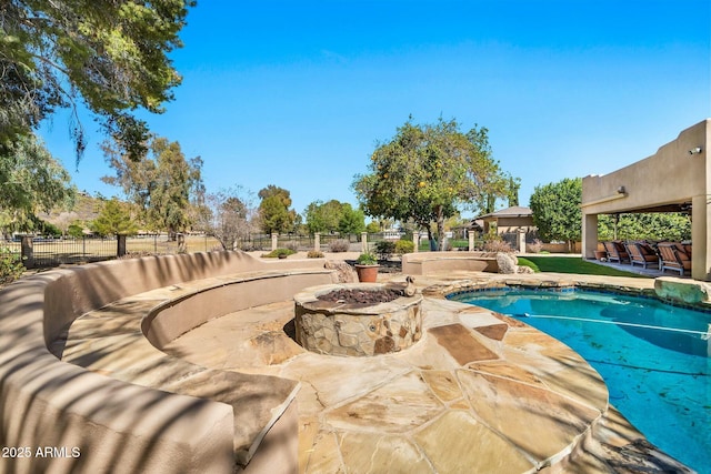 view of pool with an outdoor living space with a fire pit, a patio, fence, and a fenced in pool