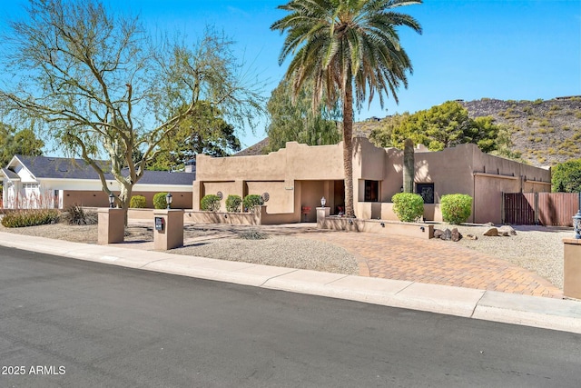 adobe home with a fenced front yard