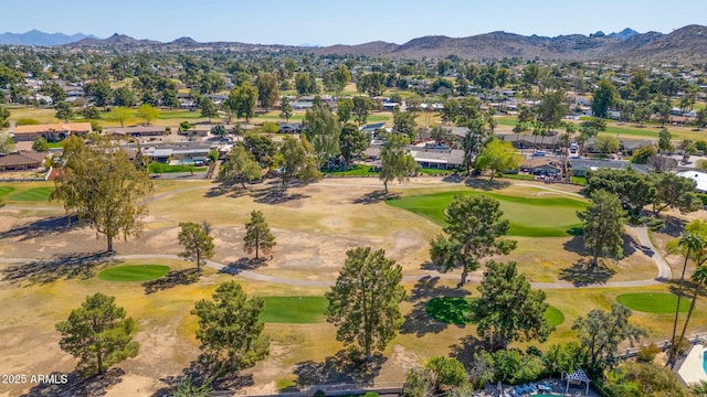 aerial view with view of golf course and a mountain view