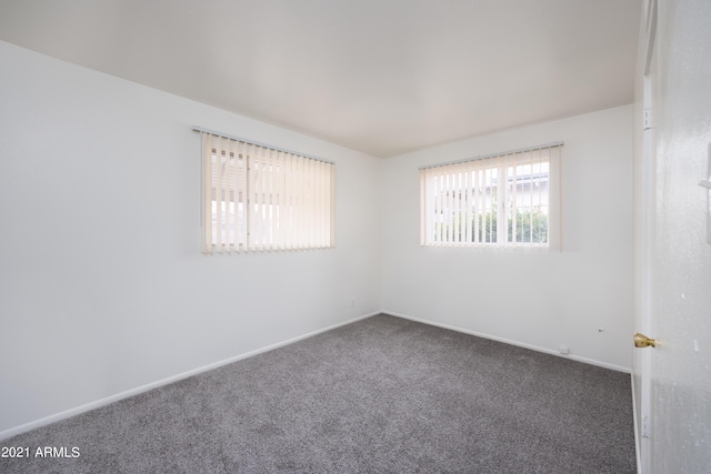 empty room with dark carpet