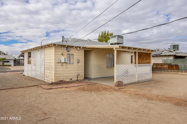 view of front of property with cooling unit and a patio