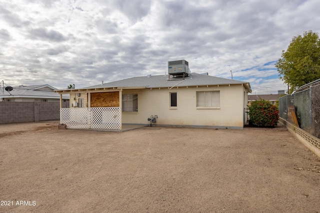 rear view of house featuring cooling unit