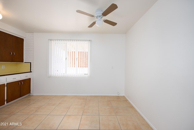 tiled empty room with ceiling fan