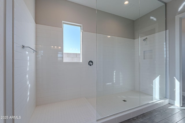 bathroom featuring a tile shower and hardwood / wood-style flooring