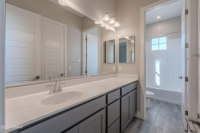 full bathroom featuring vanity, toilet, and tub / shower combination