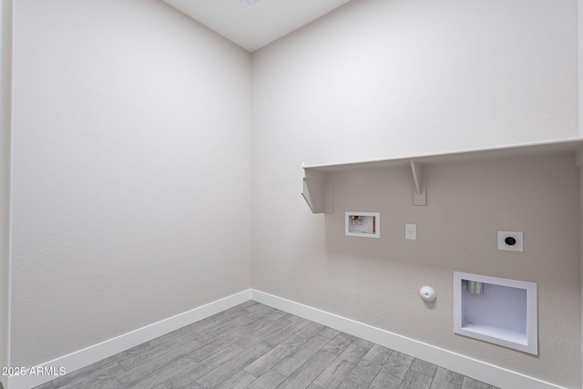 washroom featuring electric dryer hookup, hookup for a gas dryer, hookup for a washing machine, and light wood-type flooring