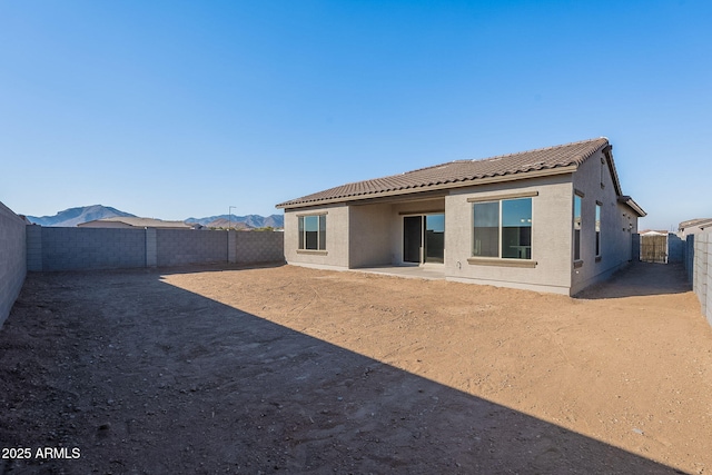 back of house featuring a mountain view