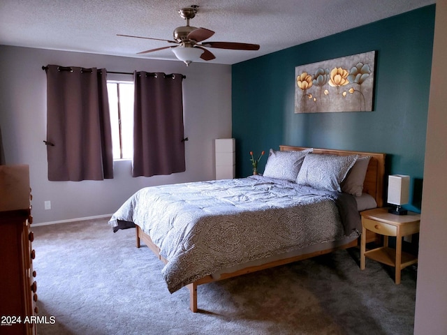 carpeted bedroom featuring ceiling fan and a textured ceiling