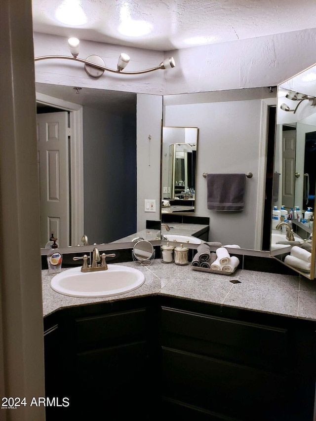 bathroom with vanity and a textured ceiling