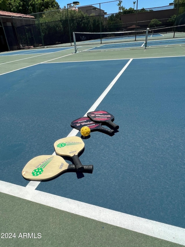 view of tennis court featuring basketball hoop