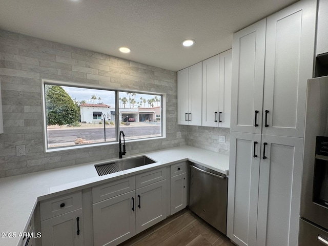 kitchen with sink, plenty of natural light, stainless steel appliances, and white cabinets