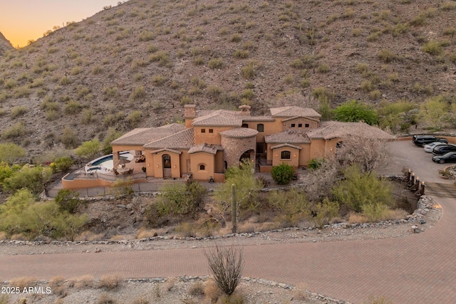 11550 E Paradise Ln, Scottsdale, AZ 85255 - view of front of home with stucco siding, a tiled roof, a mountain view, and a chimney