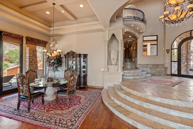 11550 E Paradise Ln, Scottsdale, AZ 85255 - dining area featuring a chandelier, arched walkways, a high ceiling, recessed lighting, and coffered ceiling