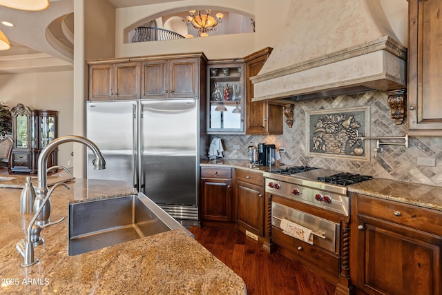 11550 E Paradise Ln, Scottsdale, AZ 85255 - kitchen featuring custom range hood, appliances with stainless steel finishes, a sink, dark wood finished floors, and tasteful backsplash