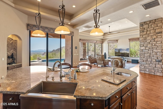 11550 E Paradise Ln, Scottsdale, AZ 85255 - kitchen featuring open floor plan, a sink, an island with sink, a mountain view, and recessed lighting