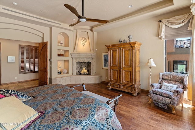 11550 E Paradise Ln, Scottsdale, AZ 85255 - bedroom with a fireplace, baseboards, wood finished floors, and recessed lighting