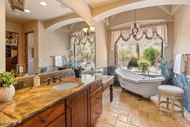 11550 E Paradise Ln, Scottsdale, AZ 85255 - bathroom featuring a chandelier, plenty of natural light, vanity, and a soaking tub