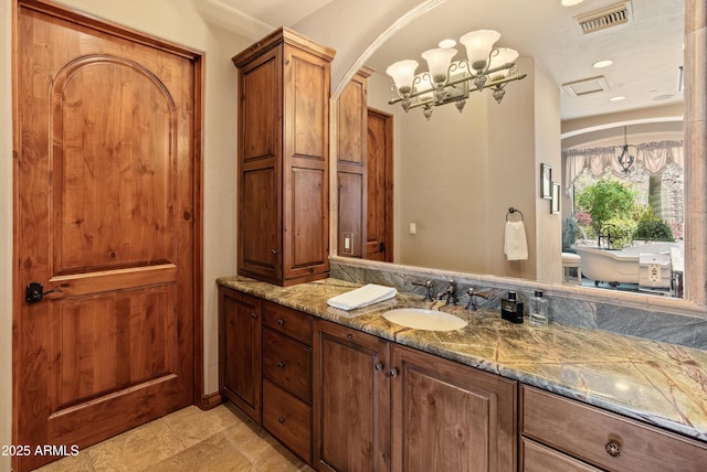 11550 E Paradise Ln, Scottsdale, AZ 85255 - full bathroom with vanity, a soaking tub, and a chandelier