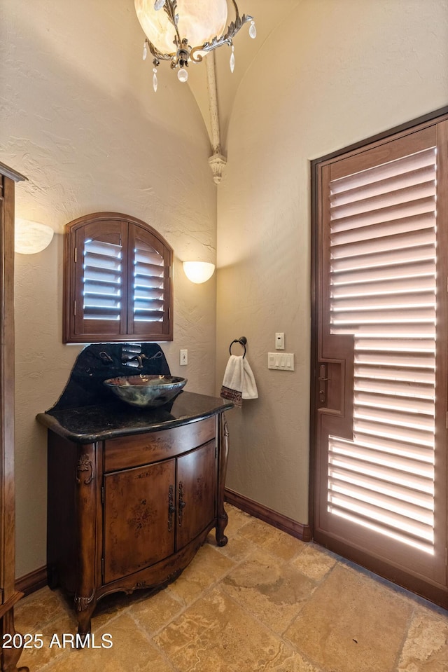 11550 E Paradise Ln, Scottsdale, AZ 85255 - bathroom featuring vanity, stone finish floors, and baseboards