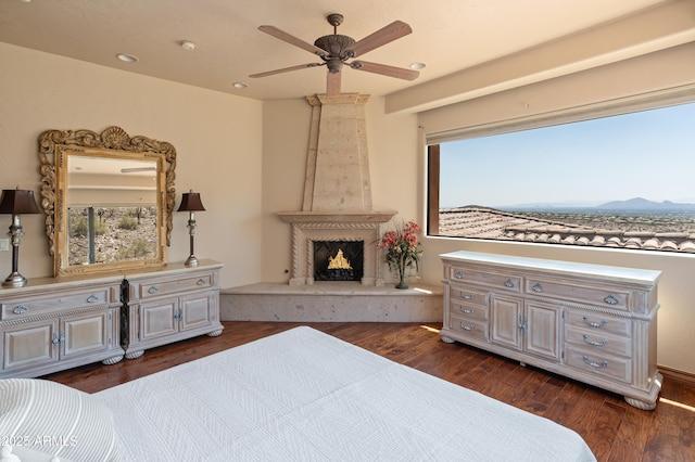 11550 E Paradise Ln, Scottsdale, AZ 85255 - bedroom featuring dark wood finished floors, recessed lighting, a premium fireplace, a mountain view, and multiple windows
