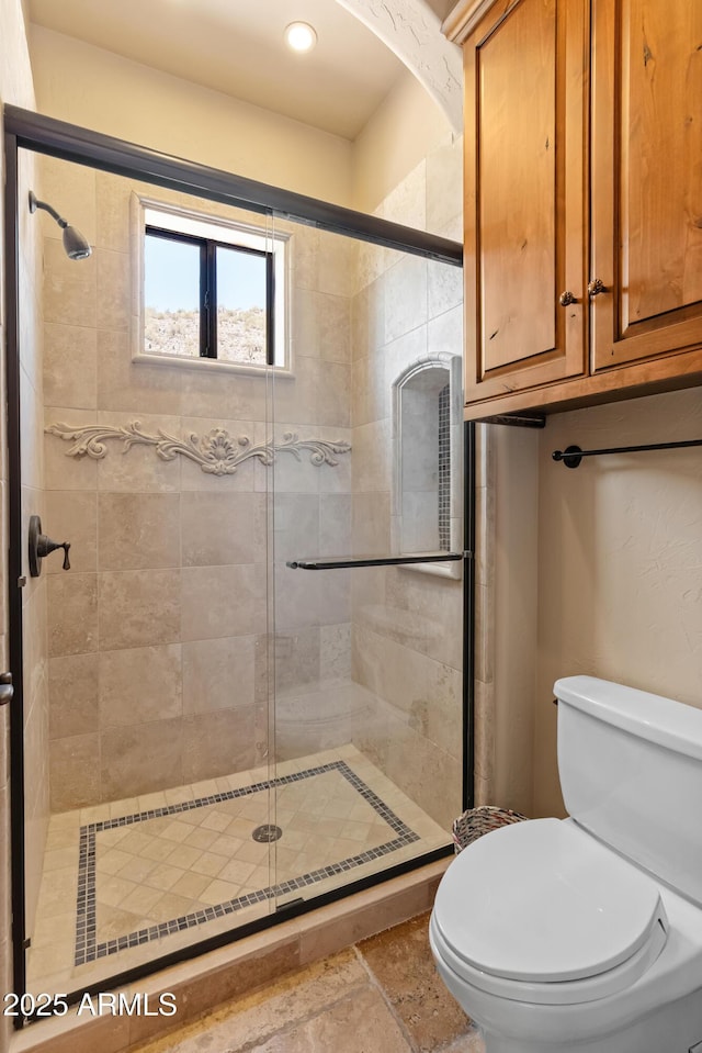 11550 E Paradise Ln, Scottsdale, AZ 85255 - bathroom featuring a shower stall, toilet, stone finish flooring, and recessed lighting