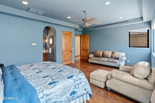 11550 E Paradise Ln, Scottsdale, AZ 85255 - bedroom featuring wood finished floors, a tray ceiling, recessed lighting, arched walkways, and a ceiling fan