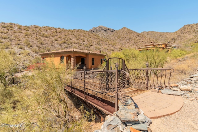 11550 E Paradise Ln, Scottsdale, AZ 85255 - rear view of house with a deck with mountain view, stucco siding, and a tile roof