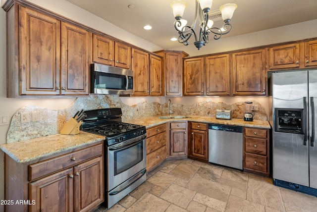 11550 E Paradise Ln, Scottsdale, AZ 85255 - kitchen featuring stainless steel appliances, a sink, a chandelier, brown cabinetry, and recessed lighting