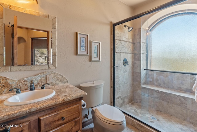 11550 E Paradise Ln, Scottsdale, AZ 85255 - bathroom featuring vanity, toilet, a stall shower, and a textured wall
