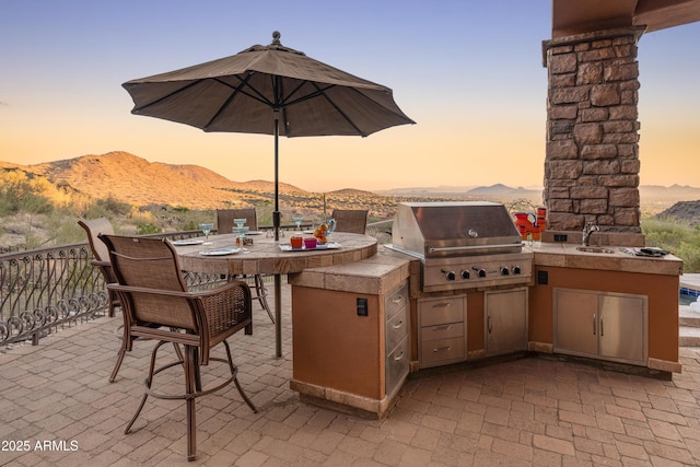 11550 E Paradise Ln, Scottsdale, AZ 85255 - patio terrace at dusk featuring a mountain view, a patio, and a sink