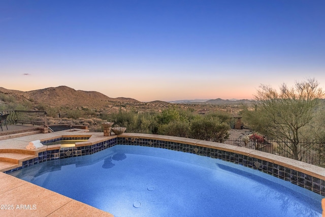 11550 E Paradise Ln, Scottsdale, AZ 85255 - pool at dusk with a mountain view and a pool with connected hot tub