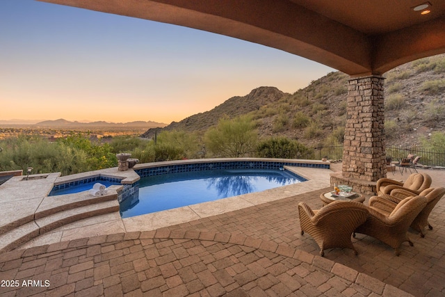 11550 E Paradise Ln, Scottsdale, AZ 85255 - pool at dusk with a patio, a mountain view, and a pool with connected hot tub