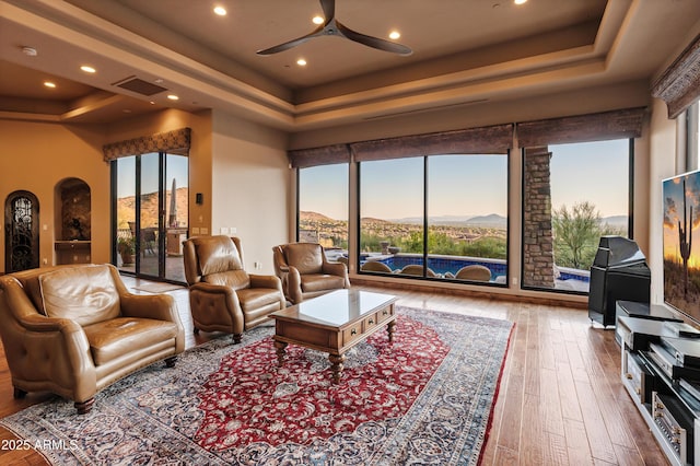 11550 E Paradise Ln, Scottsdale, AZ 85255 - living area with a tray ceiling, ceiling fan, plenty of natural light, wood-type flooring, and recessed lighting
