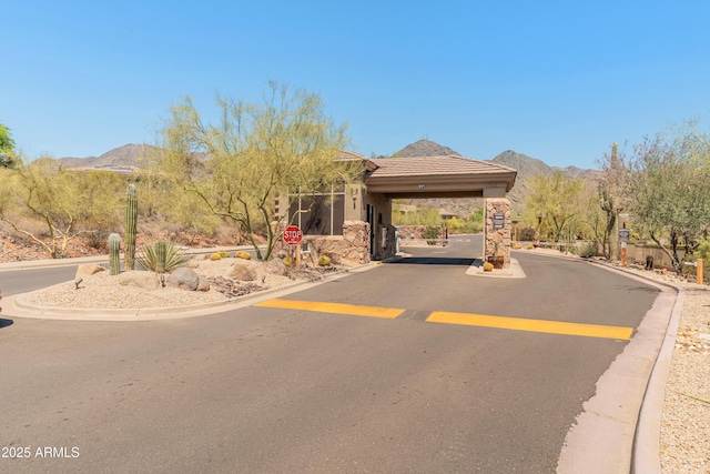 11550 E Paradise Ln, Scottsdale, AZ 85255 - view of asphalt street with a mountain view, curbs, and a gated entry