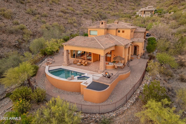 11550 E Paradise Ln, Scottsdale, AZ 85255 - rear view of property featuring a patio, a tile roof, stucco siding, a chimney, and a pool with connected hot tub
