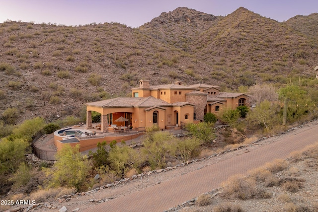 11550 E Paradise Ln, Scottsdale, AZ 85255 - view of front facade featuring a patio, stucco siding, a mountain view, and a chimney