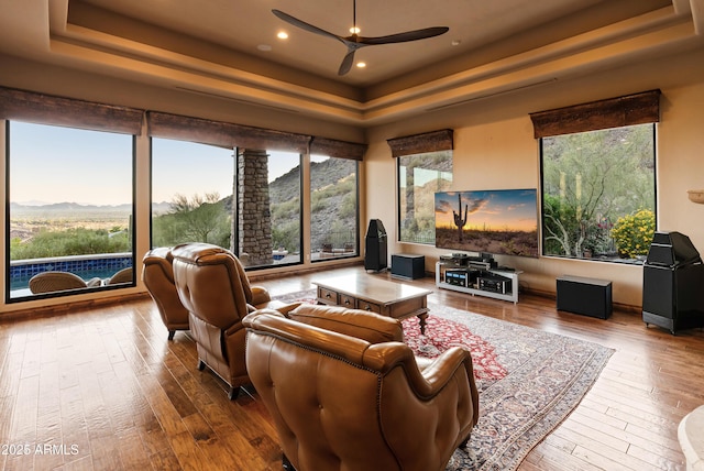 11550 E Paradise Ln, Scottsdale, AZ 85255 - living area with a raised ceiling, ceiling fan, hardwood / wood-style flooring, a mountain view, and recessed lighting