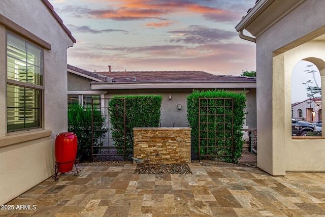 20784 W Minnezona Ave, Buckeye, AZ 85396 - patio terrace at dusk featuring a gate and a patio area